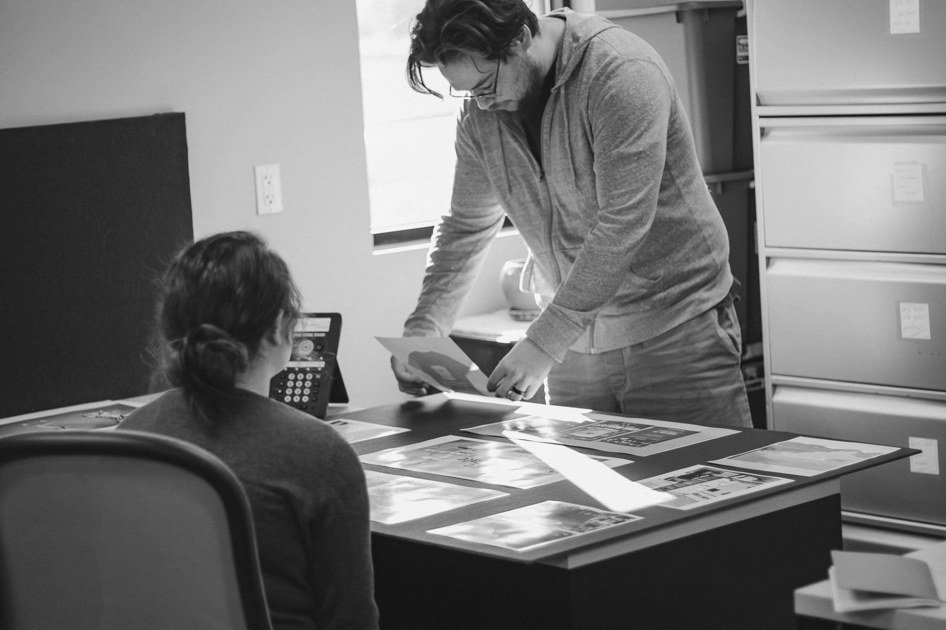 man and women organizing papers