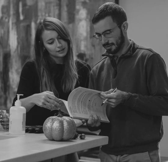 man and woman looking at booklet