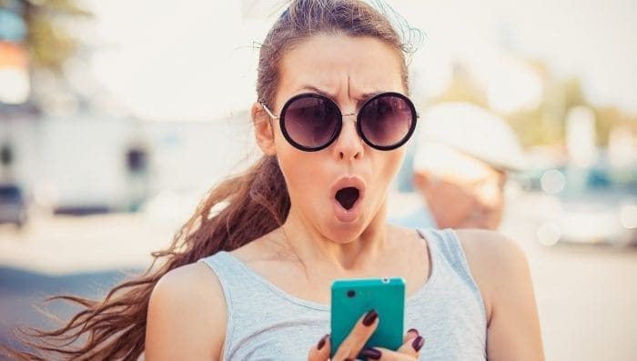 woman shocked by something on phone