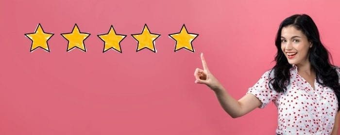 woman smiling and pointing at five stars