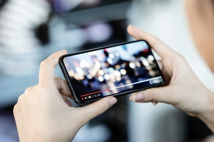 Woman watching video on mobile phone