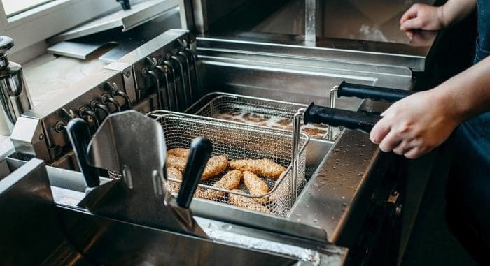 man cooking fried food