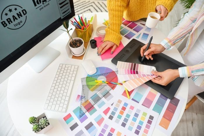 two woman reviewing color pallets