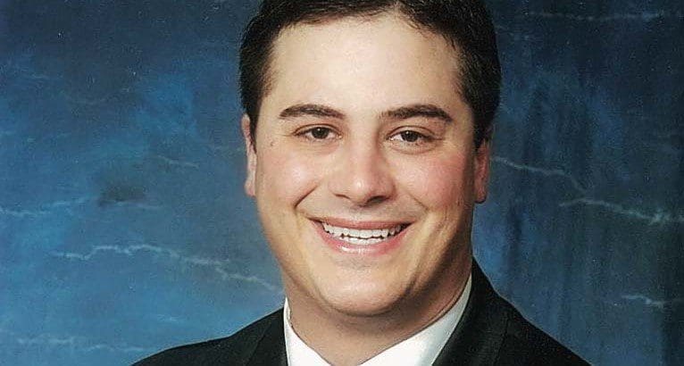 Man headshot in front of blue background